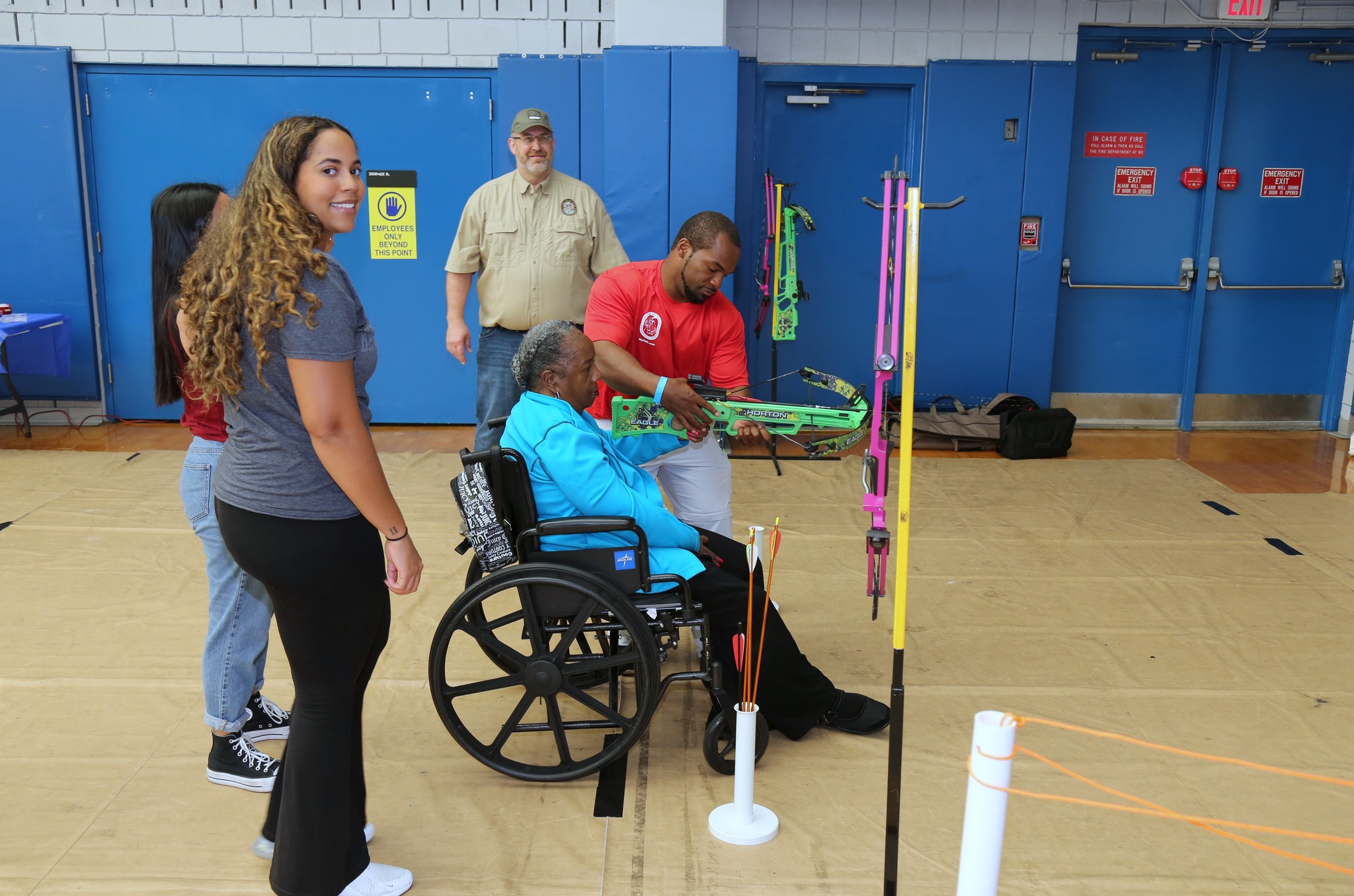 woman in a wheelchair shooting a crossbow