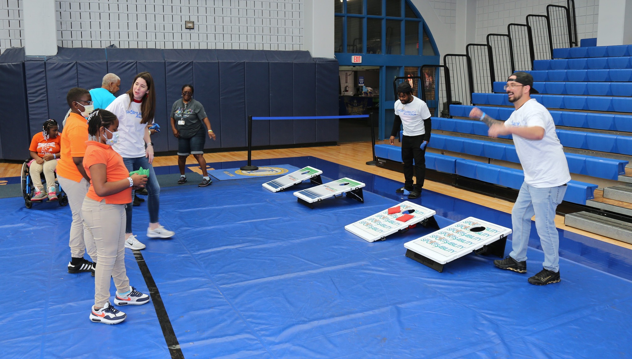 people playing bean bag toss in the gym