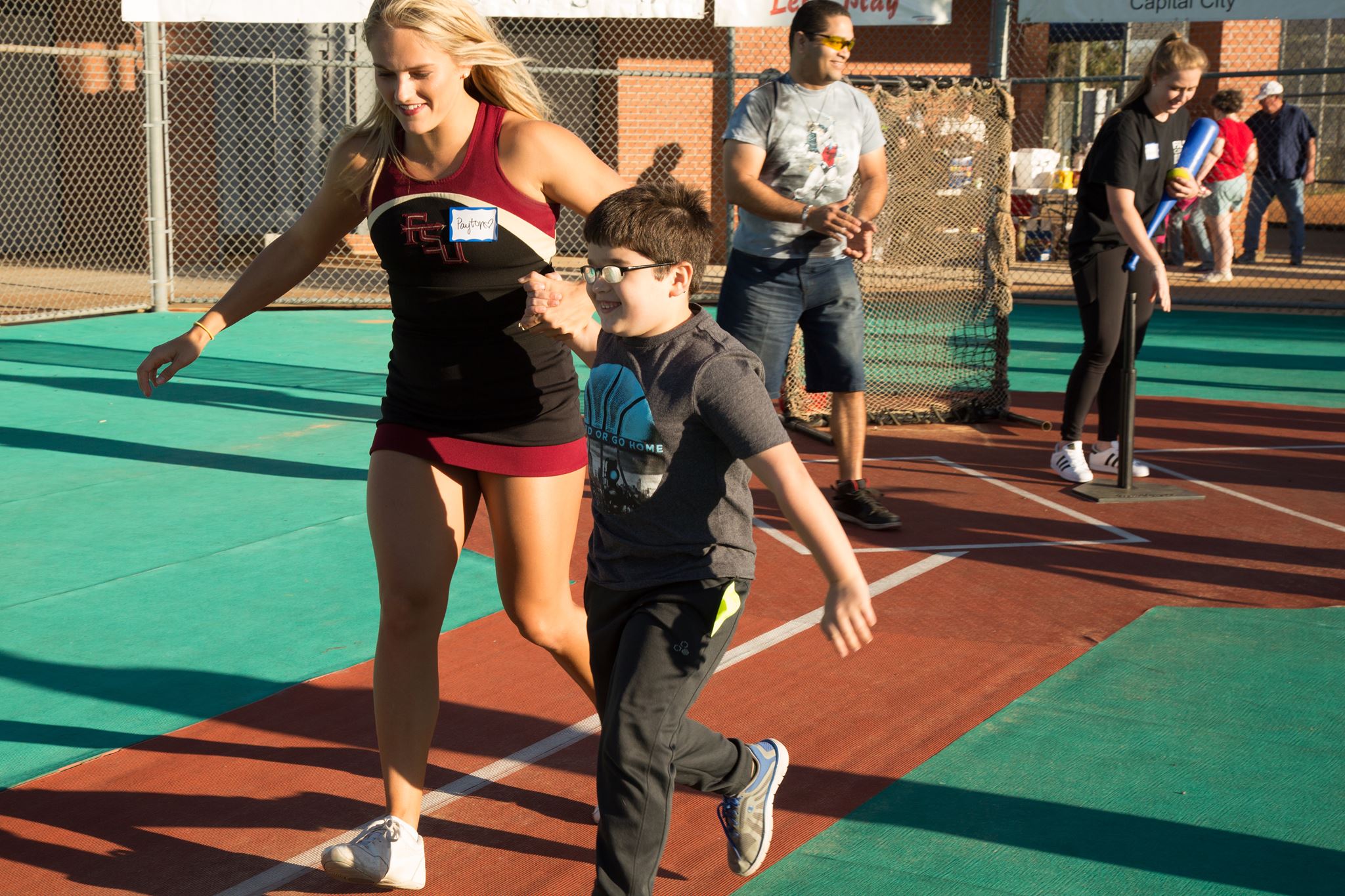 Cheerleader running with Miracle Athlete