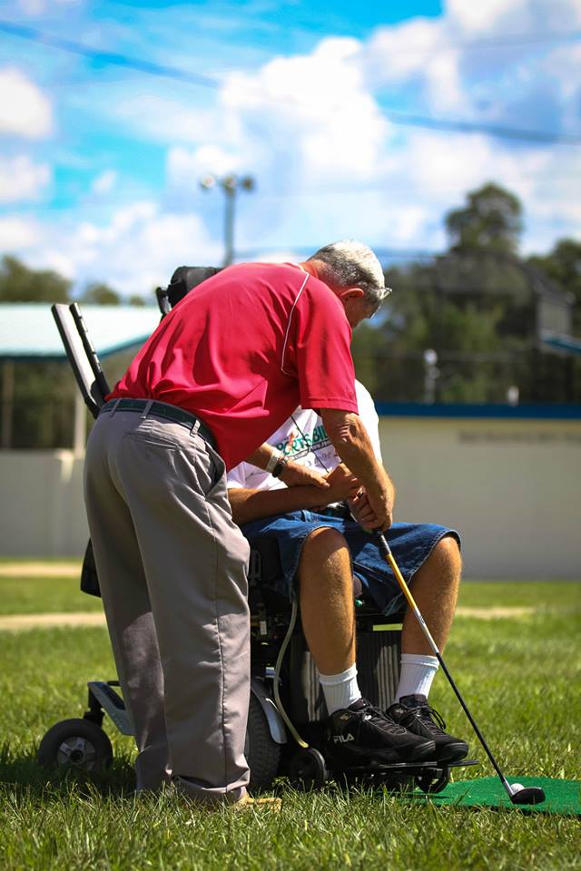 Photo of a person with a disability playing golf